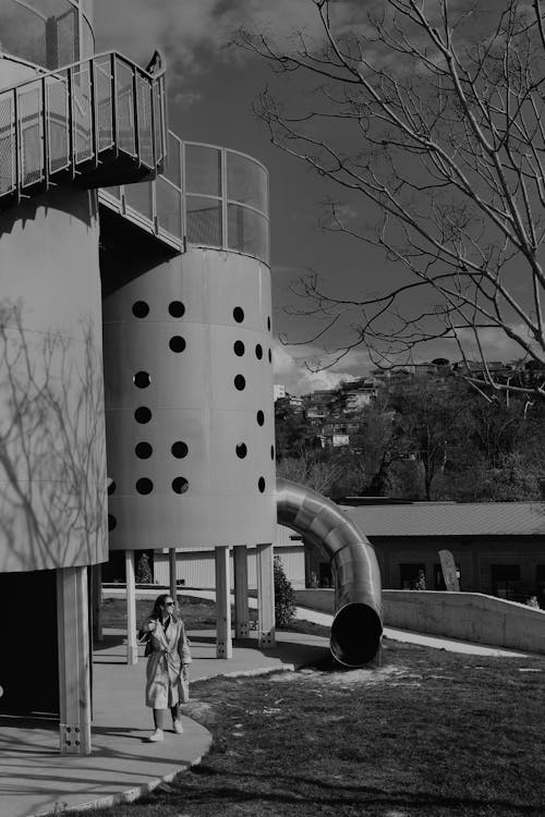 Free Black and White Photo of a Woman Walking in a Park  Stock Photo