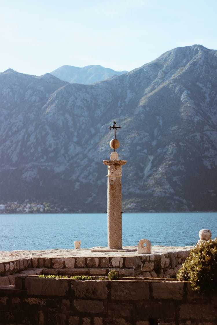 Cross On Wall Over Lake