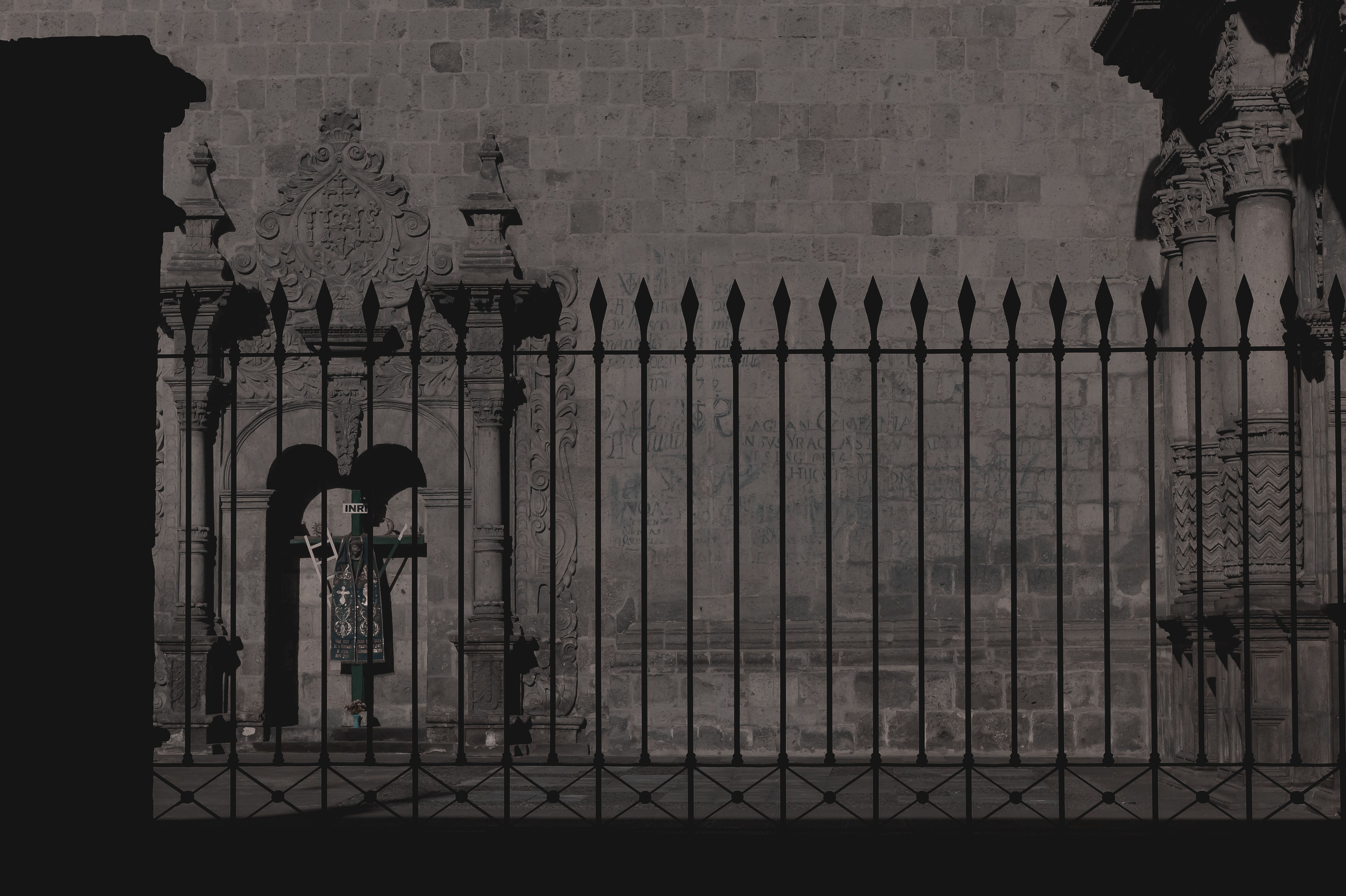 Black-and-white photo of a fence outside a church