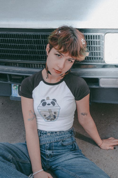 Portrait of Woman in T-shirt Sitting by Car