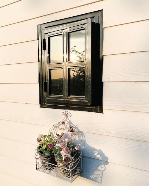 Free A window with a basket on the side of a house Stock Photo