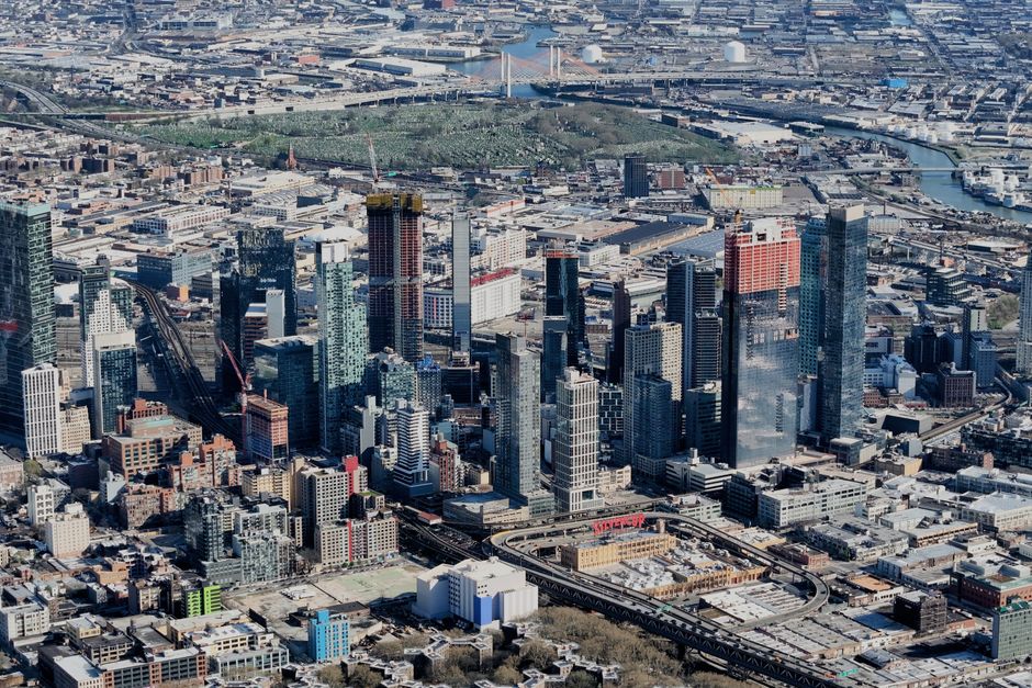 Aerial view of Buffalo, New York skyline with residential areas and Lake Erie in the background, featuring modern buildings and historic architecture