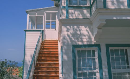 Free A white house with blue trim and white stairs Stock Photo