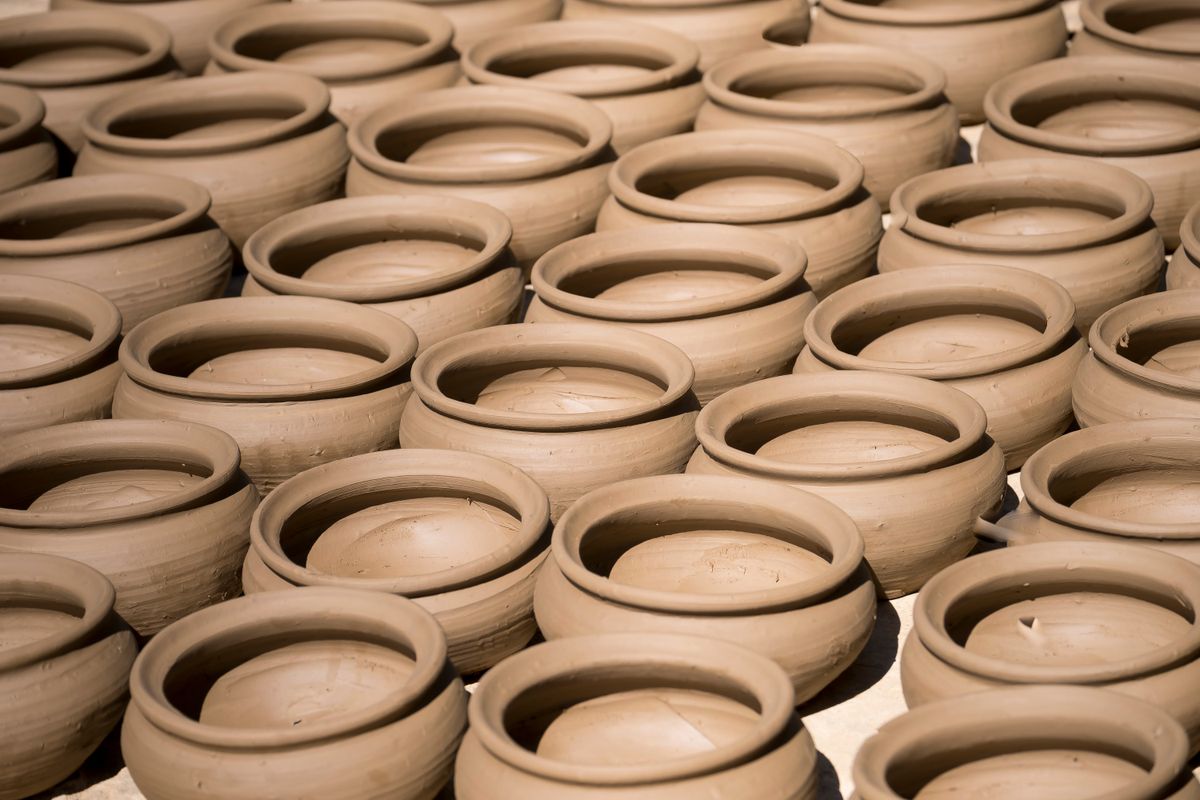 Rows of unfired clay vessels drying - The Authority of God to Make Law
