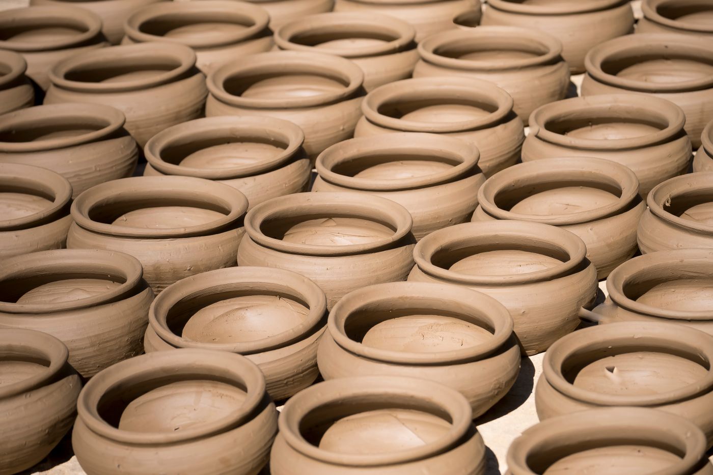 Hands shaping clay on a potter's wheel in Stoke-on-Trent