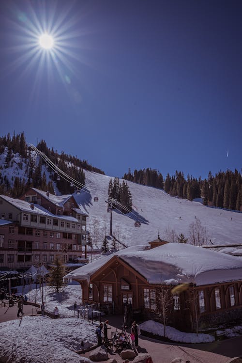 A ski resort with a large sun shining over it