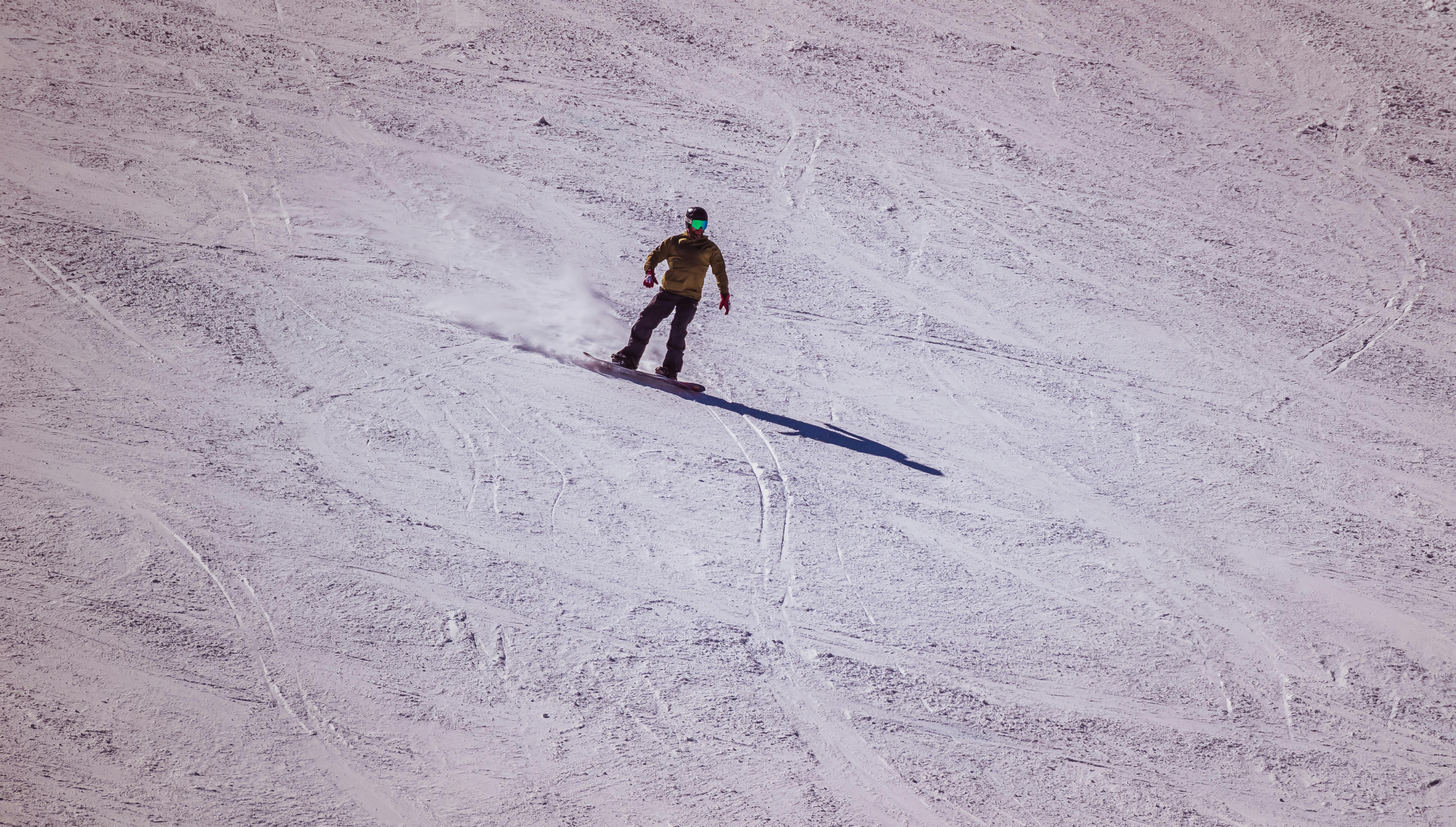 Prescription Goggle Inserts - Snowboarder enjoys a thrilling ride down a snowy mountain in winter.