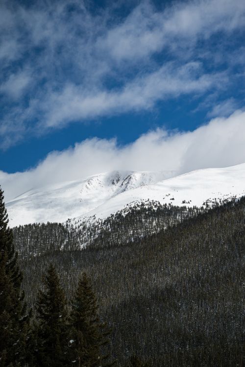 Free Breathtaking view of a snow-covered mountain peak under a bright blue sky, perfect for winter scenery. Stock Photo