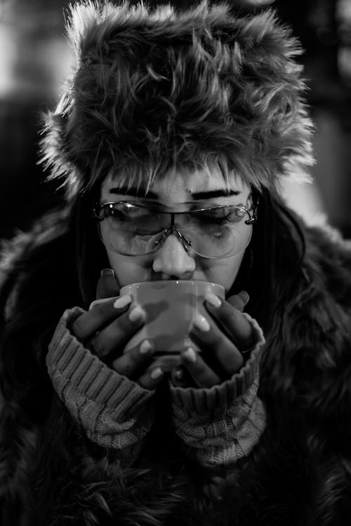 Free A woman in a fur hat drinking coffee Stock Photo