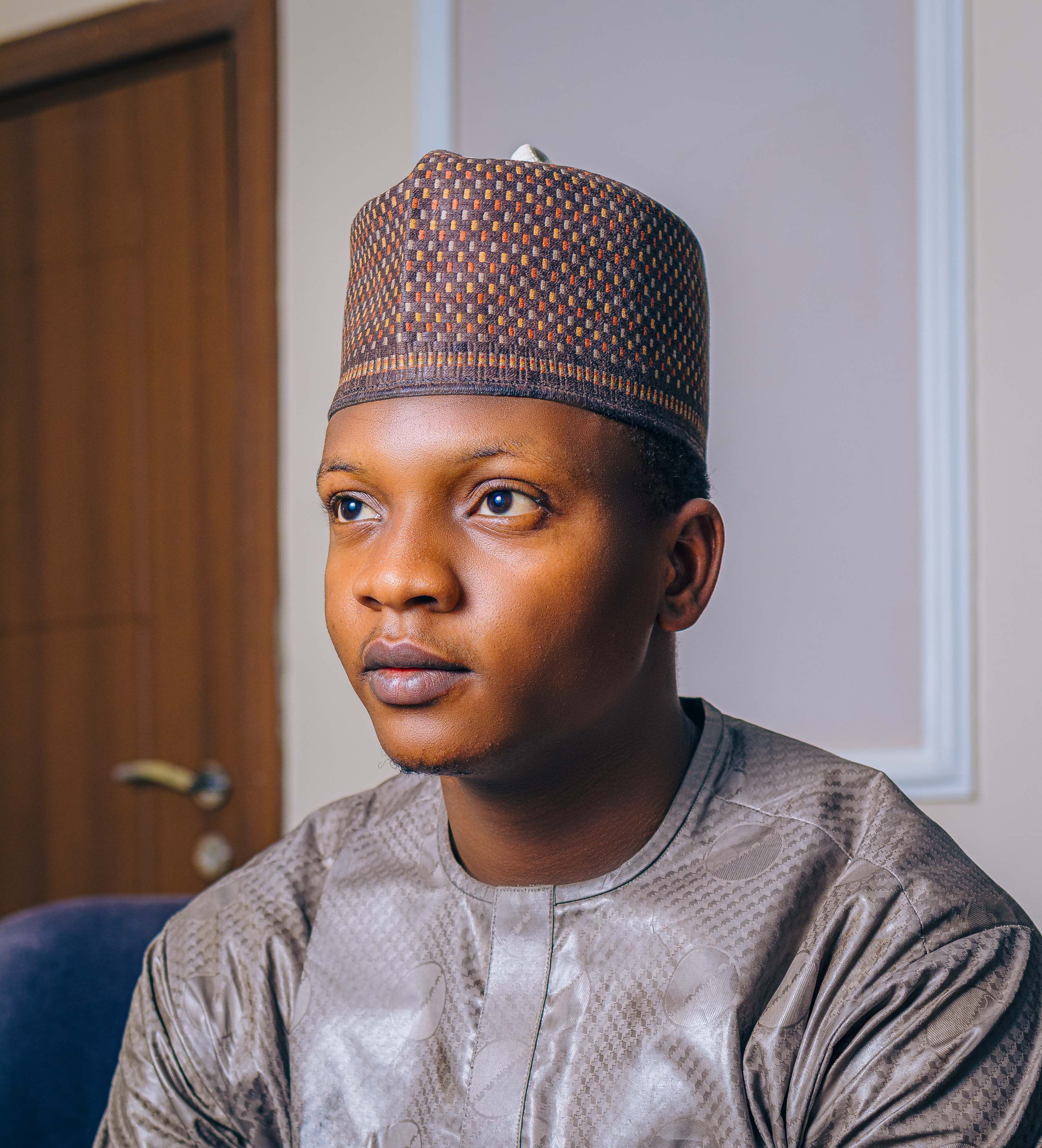 A thoughtful portrait of a man in traditional attire, showcasing cultural heritage.