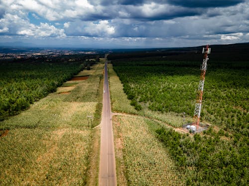 An aerial view of a road and a cell tower