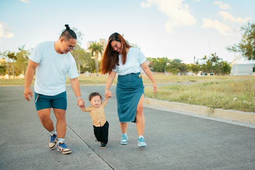 A family walking on a road with a child