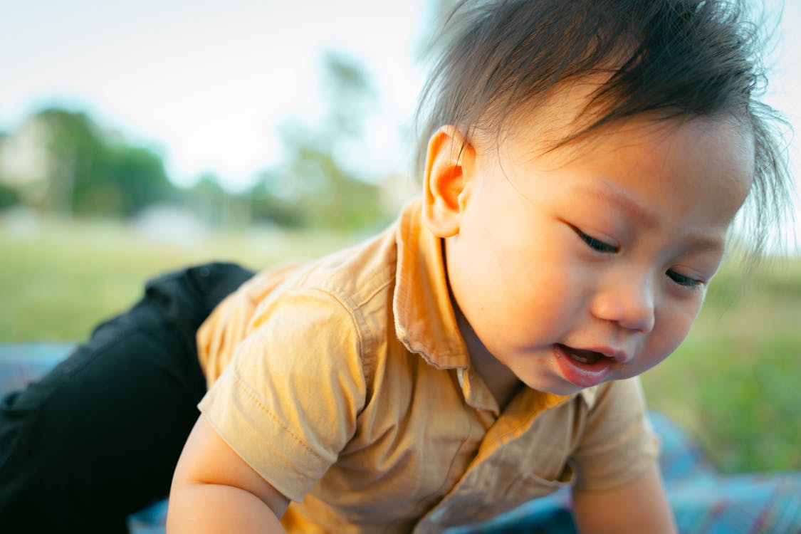 Free A baby is playing on a blanket with a toy Stock Photo