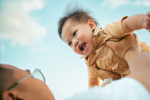 Free Father Lifting Smiling Son Stock Photo