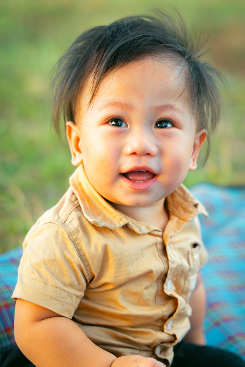 Toddler smiling outdoors at golden hour — photo by Kenneth Surillo on Pexels