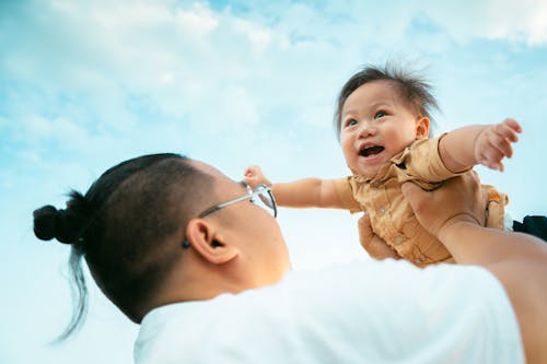 A man holding a baby in the air