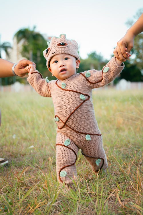 Free A baby in a mummy costume running in the grass Stock Photo