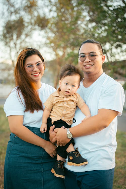 Free A family poses for a photo in front of trees Stock Photo