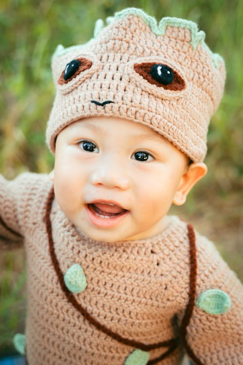 Free A baby in a crocheted costume with a hat Stock Photo
