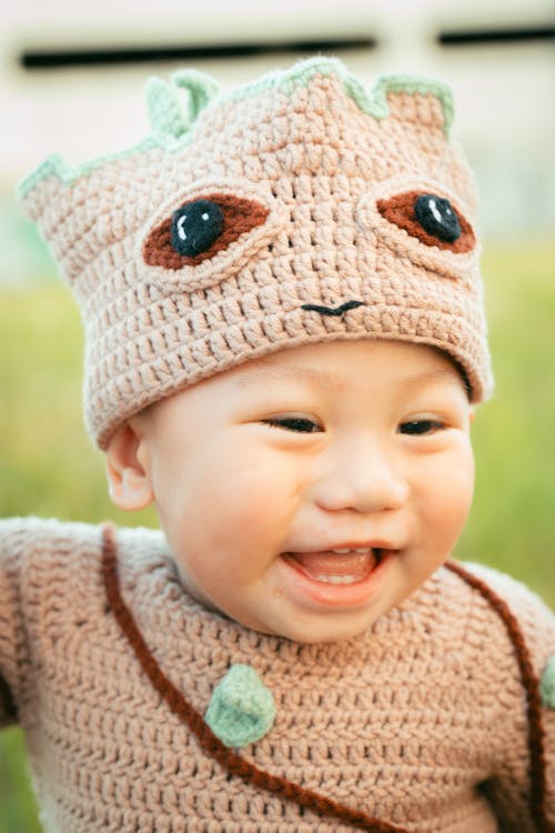 Free A baby in a crocheted costume with a smile Stock Photo