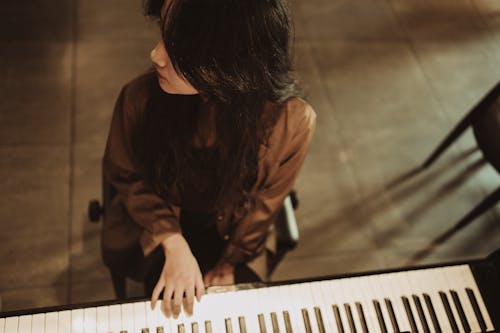 A woman playing the piano in a room