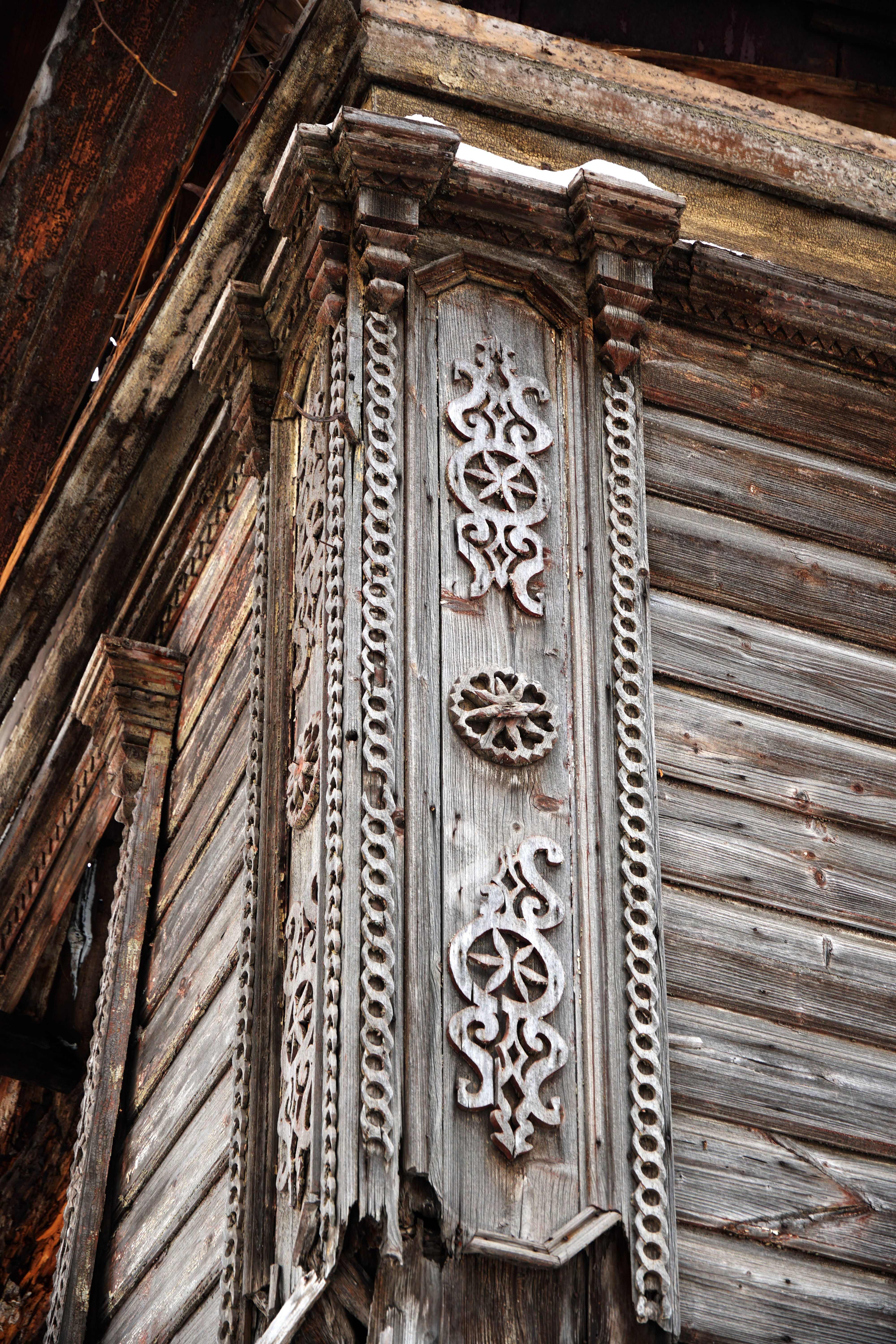 Close-up of ornate wooden architectural detail with vintage design elements.