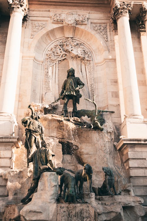 A statue of a man and a woman on top of a fountain