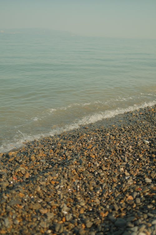 Close-up on Small Sea Waves Hitting the Shore