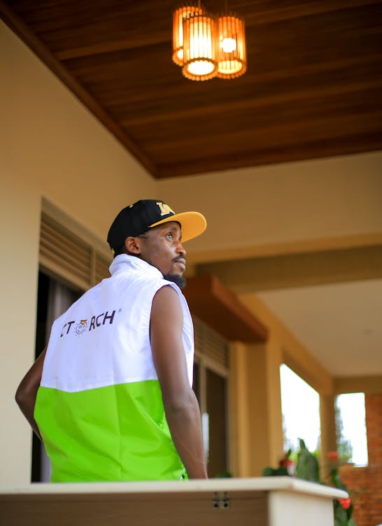 Free A man in a vest and vest standing in front of a house Stock Photo