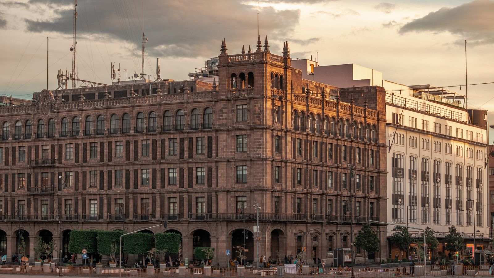 A beautiful view of a historic building in Mexico City at sunset, showcasing its architectural details.