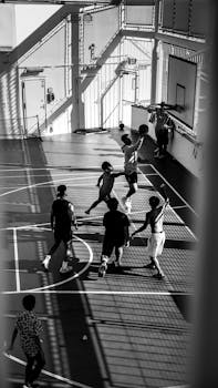 High-energy basketball game on an outdoor court in Australia, showcasing teamwork and movement.