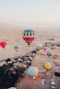 Hot Air Balloons Flying over an Edge of a Desert City