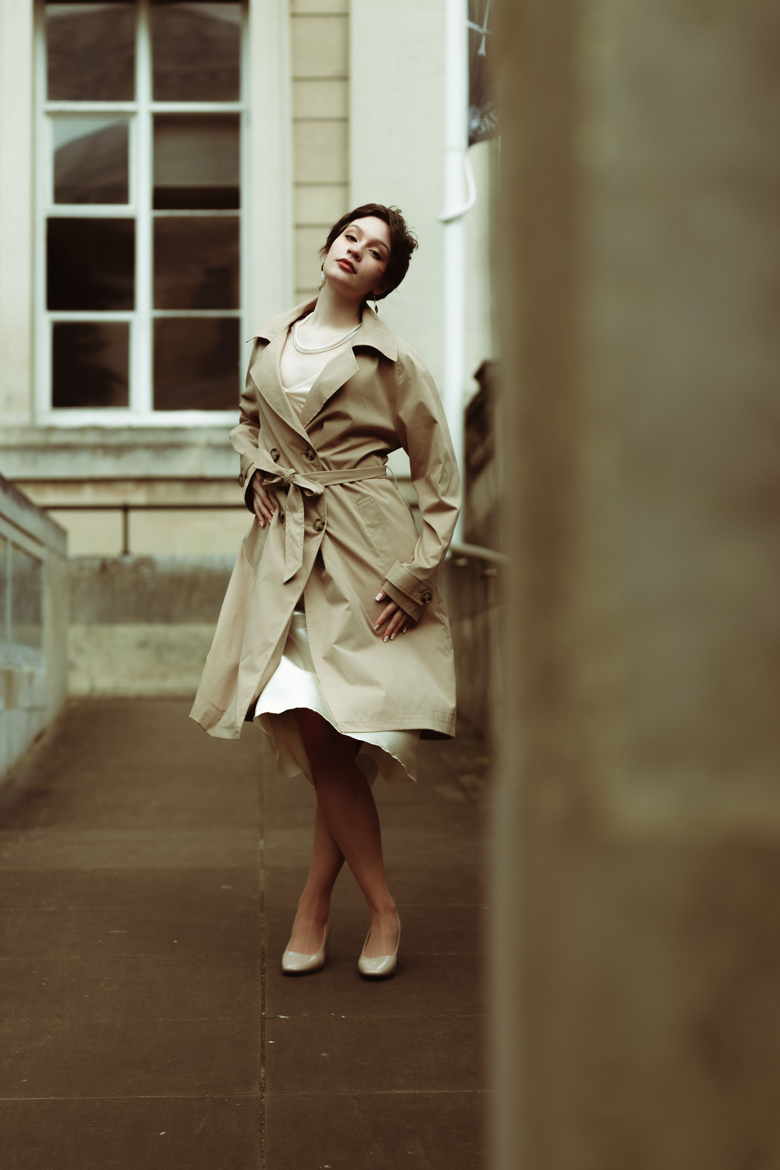 Elegant Young Woman with Short Hair Posing in a Trench Coat · Free ...
