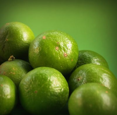 Fresh key limes up close showing natural green color and texture