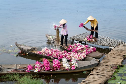 Two People Holding Flowers