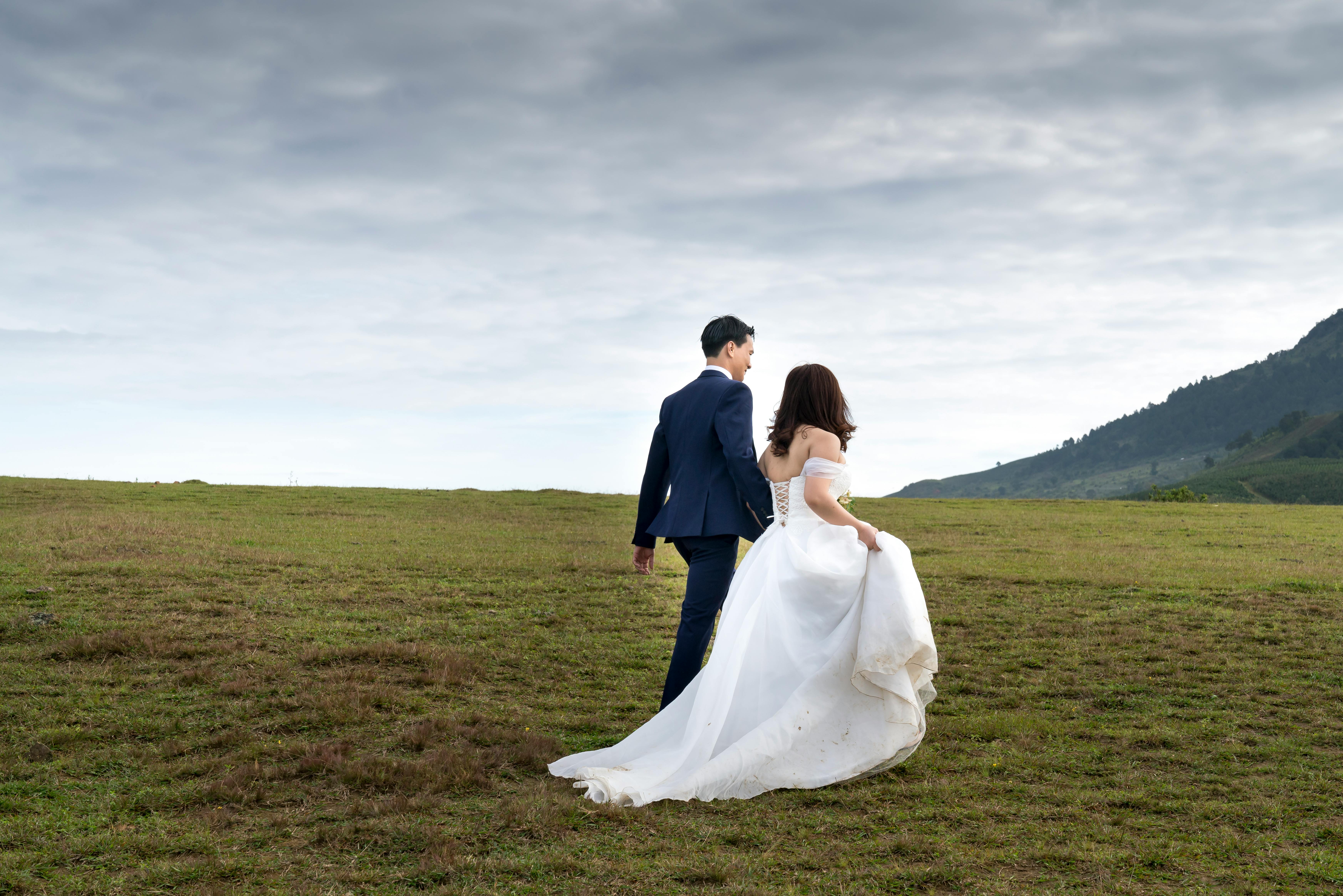 photo of couple on grass field