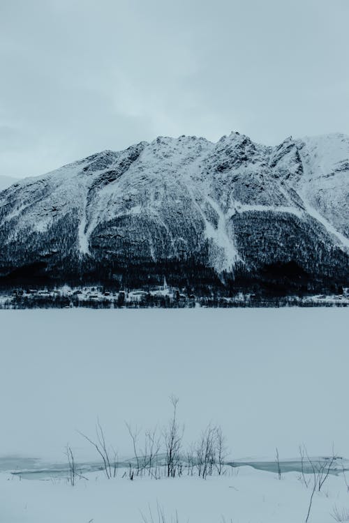 Free A snow covered mountain with a lake in the background Stock Photo