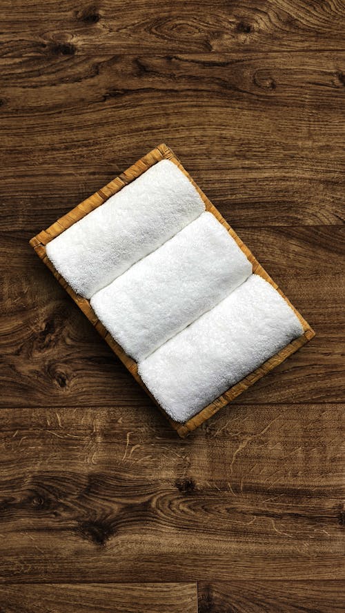 A white towel on a wooden surface