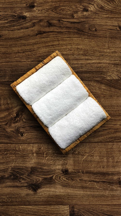 Free A white towel on a wooden surface Stock Photo