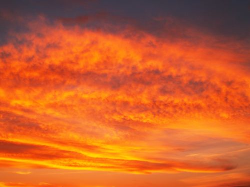 Free Captivating sunset with vibrant orange and gold hues filling the sky. Stock Photo