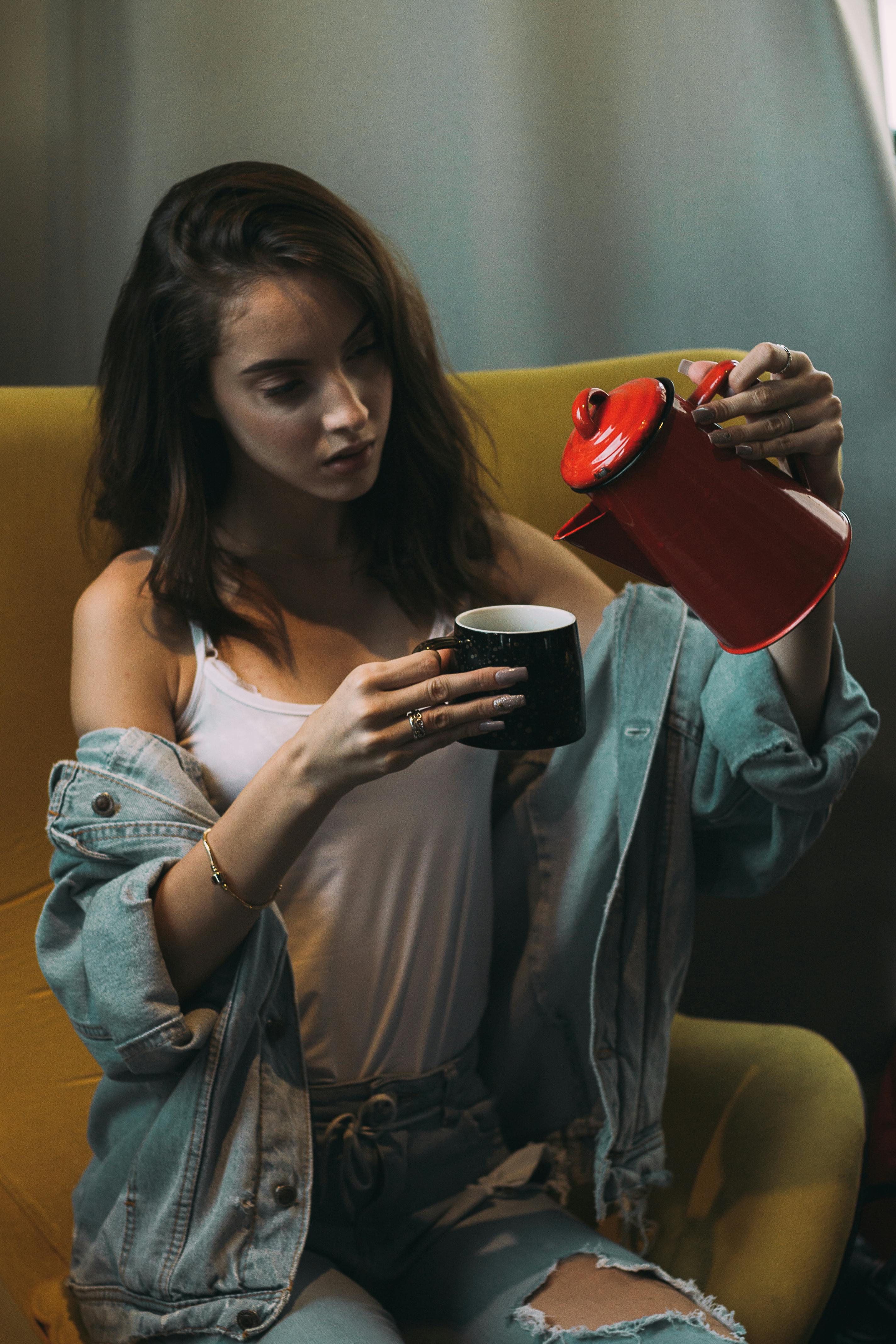 Woman Wearing White Tank Top Pouring Coffee on Mug