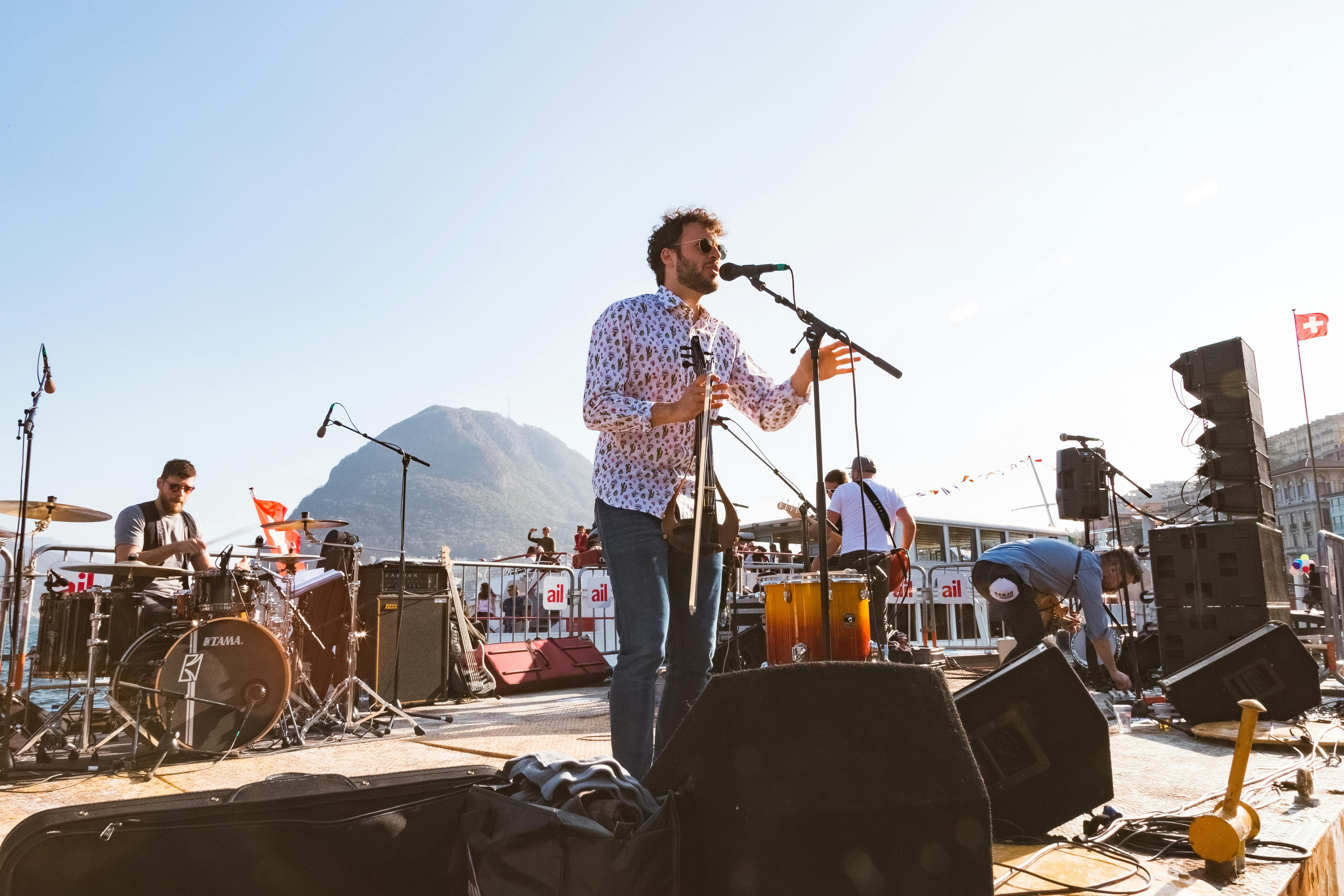 Man Singing on Stage Using Microphone