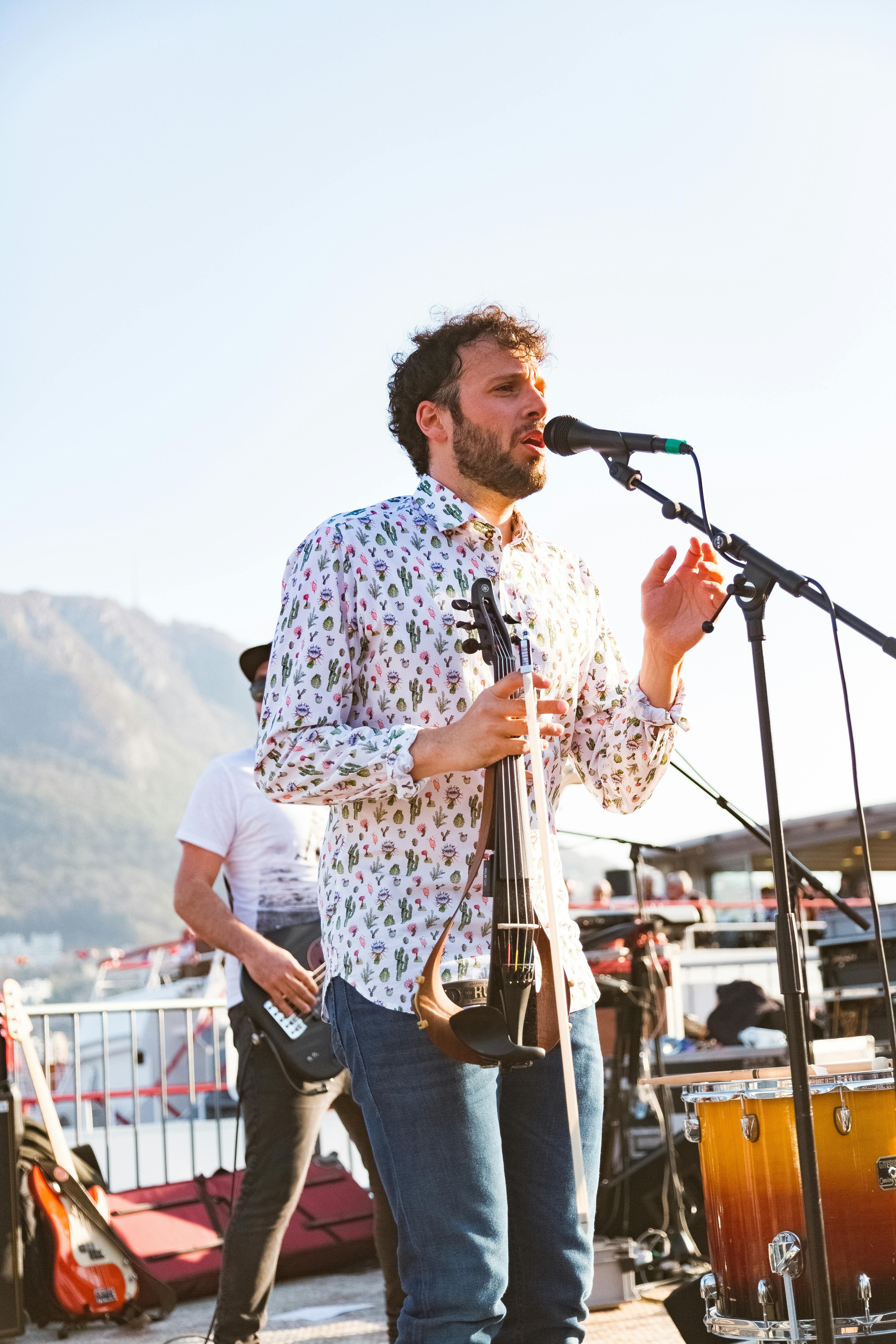 Photo of a Man Singing on Stage