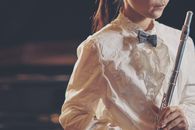 Woman Wearing White Long-sleeved Top Holding Grey Flute
