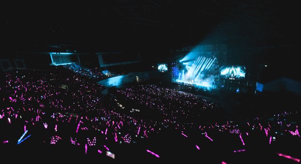 Live show with blue stage lights and crowd