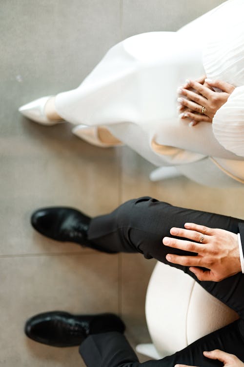 Free A couple sitting on a chair with their hands on each other Stock Photo