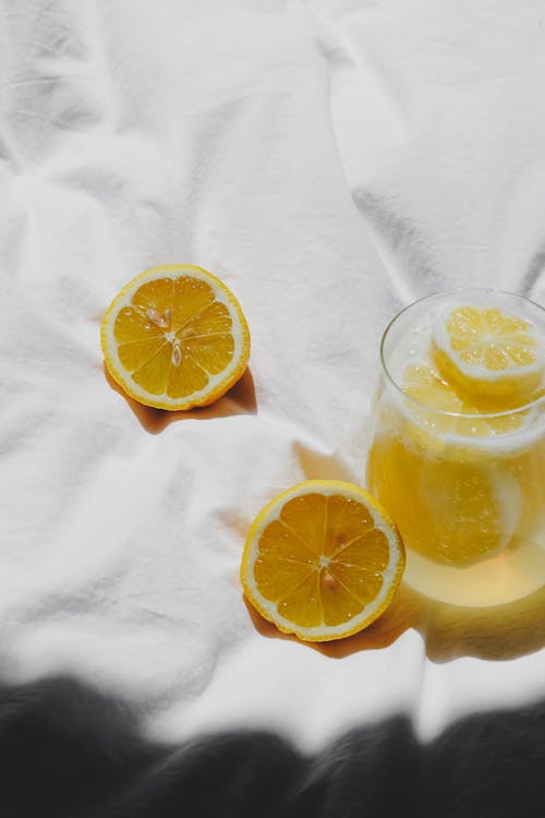 Free A glass of lemonade with slices of lemon on a white sheet Stock Photo