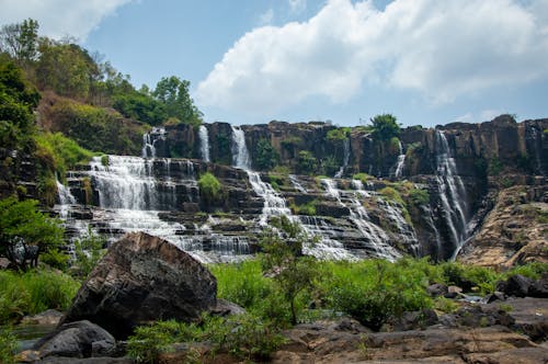 A waterfall in the middle of a green field