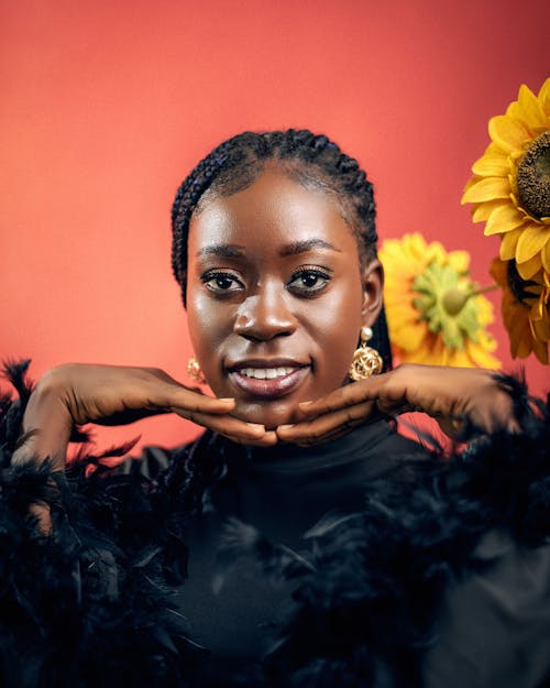 Free A woman with black hair and sunflowers Stock Photo