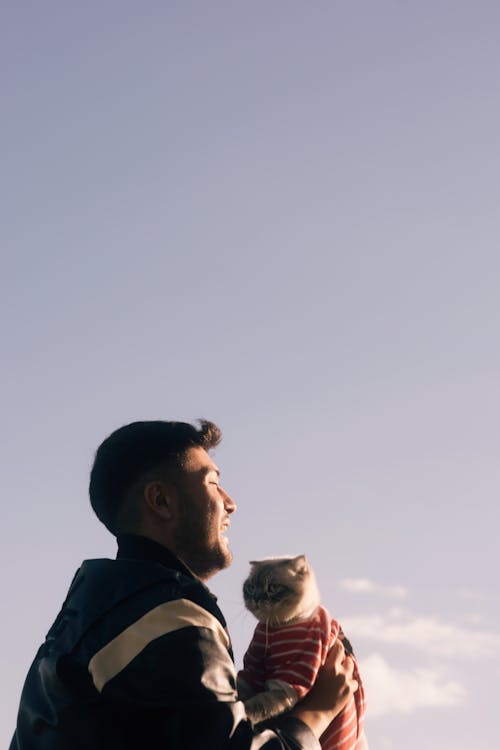 A man holding a cat in his arms